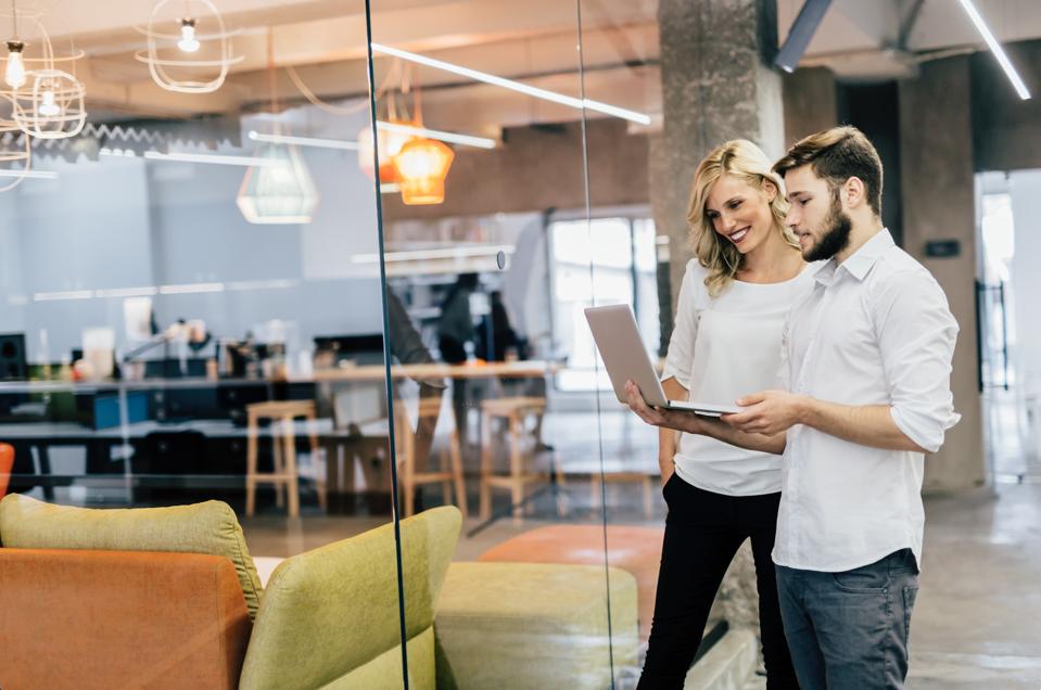 man and woman co-working in office