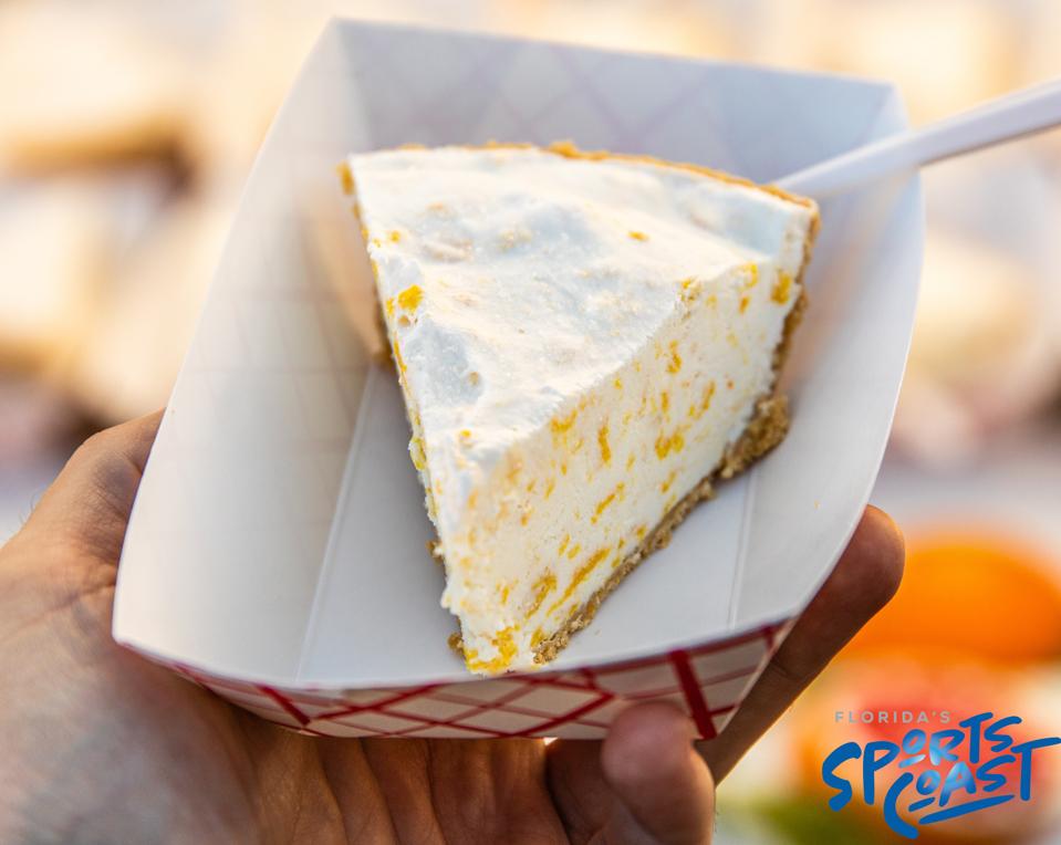 A slice of Kumquat Pie being held in a cardboard dish