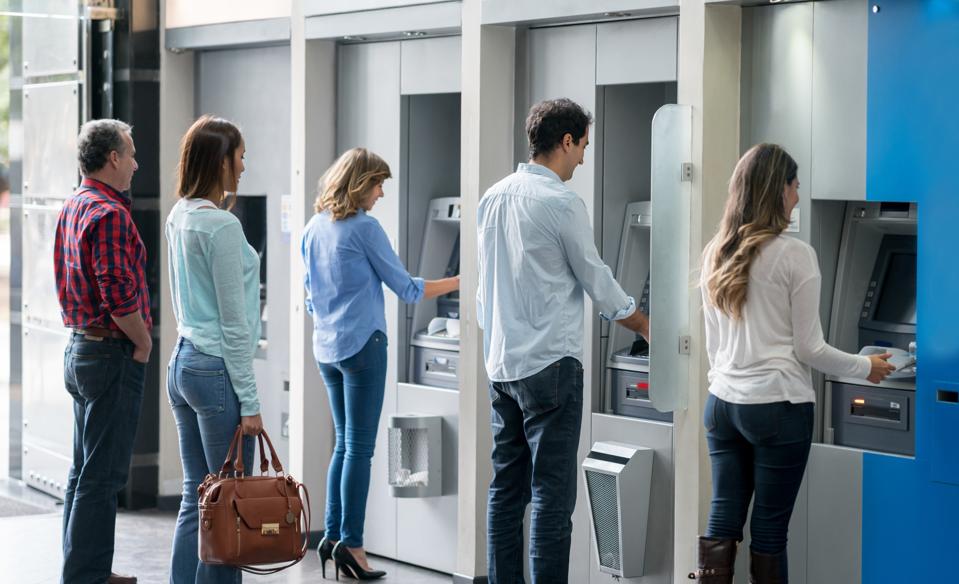 Personas en una fila en un cajero automático