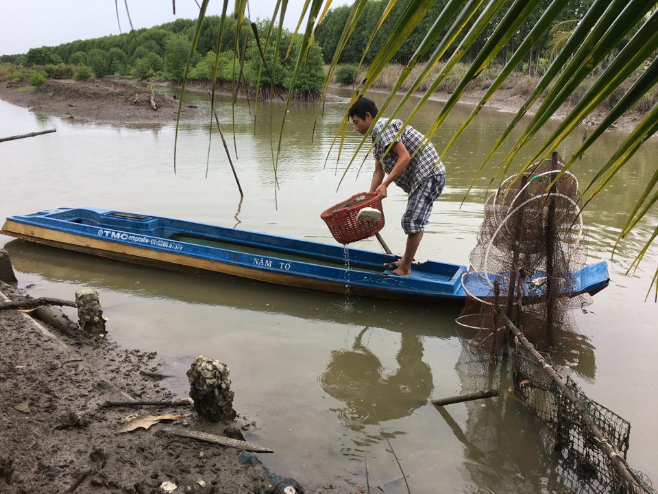 A person in a boat holding a basket