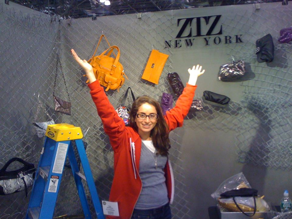 Zara Terez Tisch setting up the booth at one of her first tradeshows for her handbag line