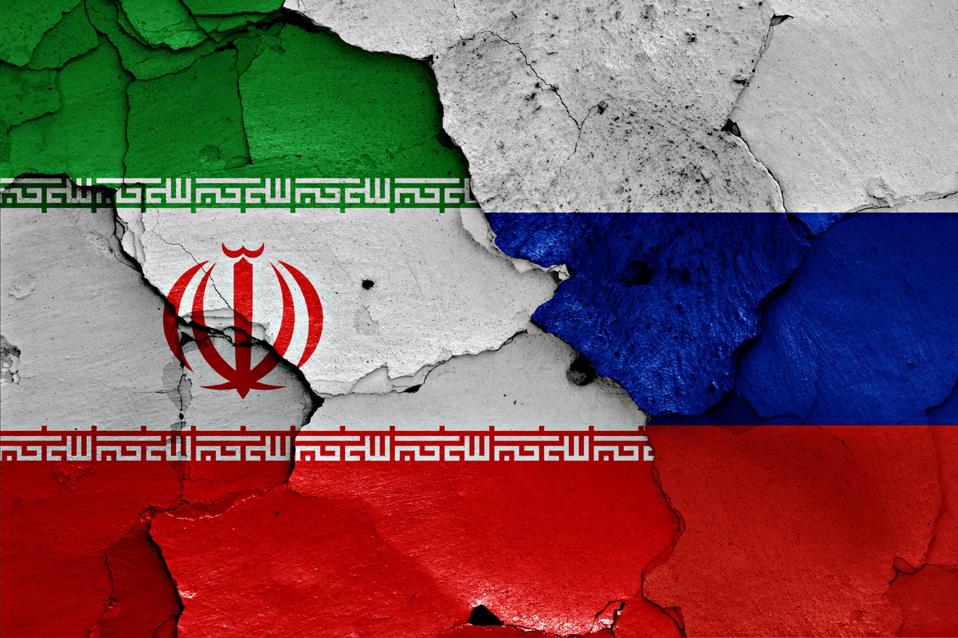 flags of Iran and Russia painted on cracked wall
