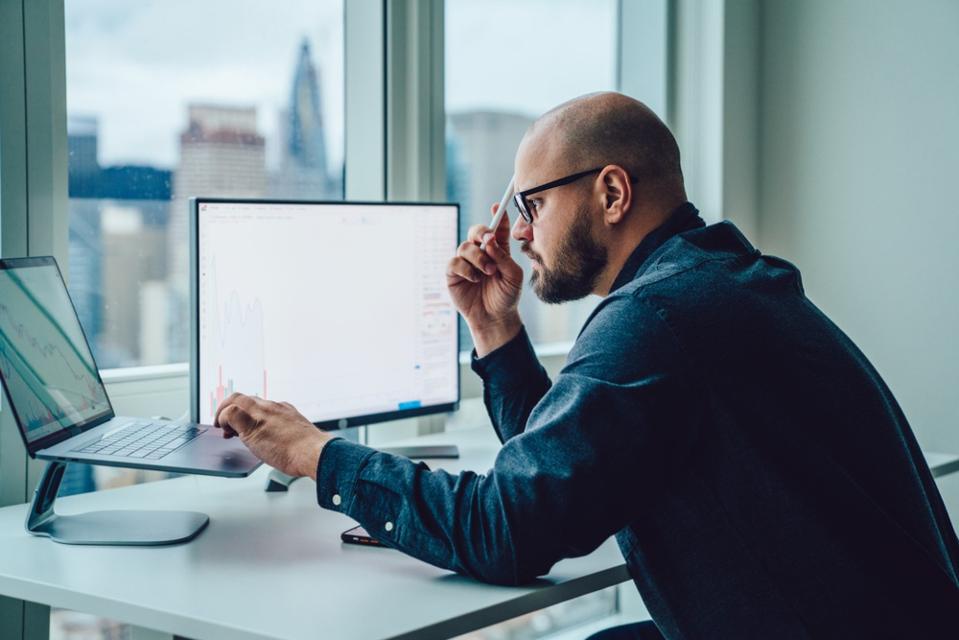 Back,View,Of,Businessman,Sitting,At,Office,Desktop,Front,Pc