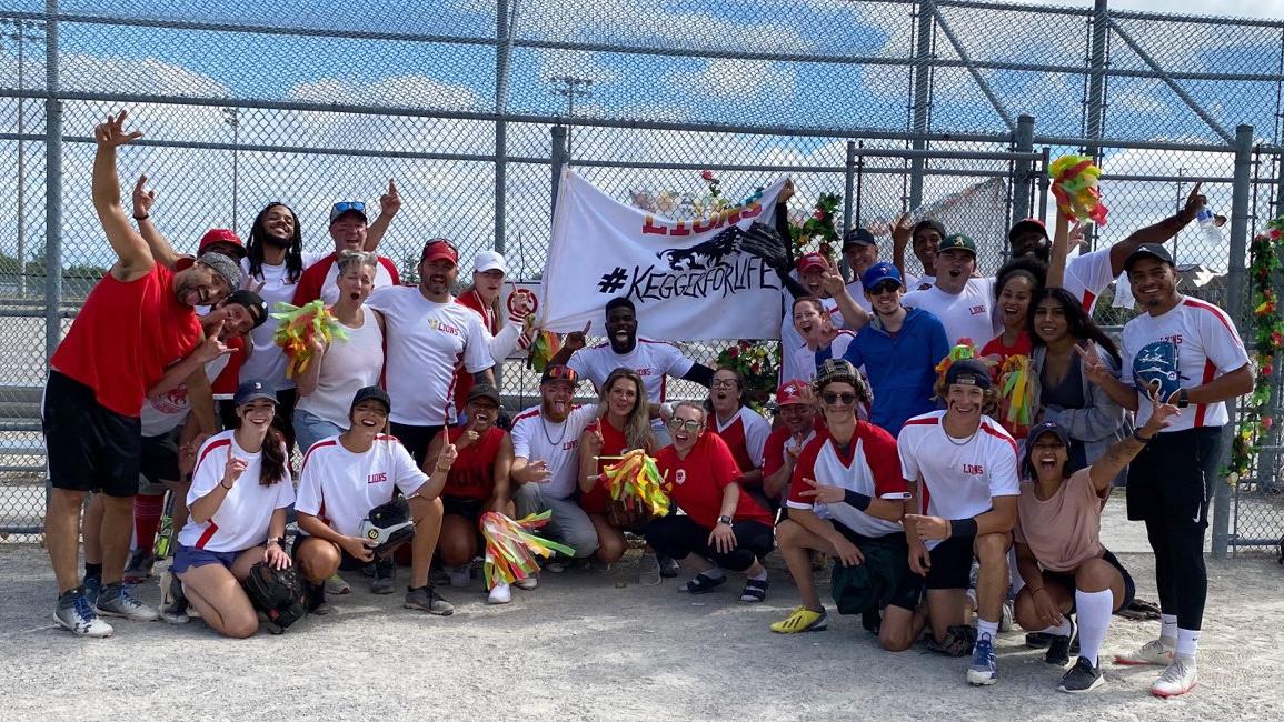El personal posa para una foto de celebración en un partido de béisbol.