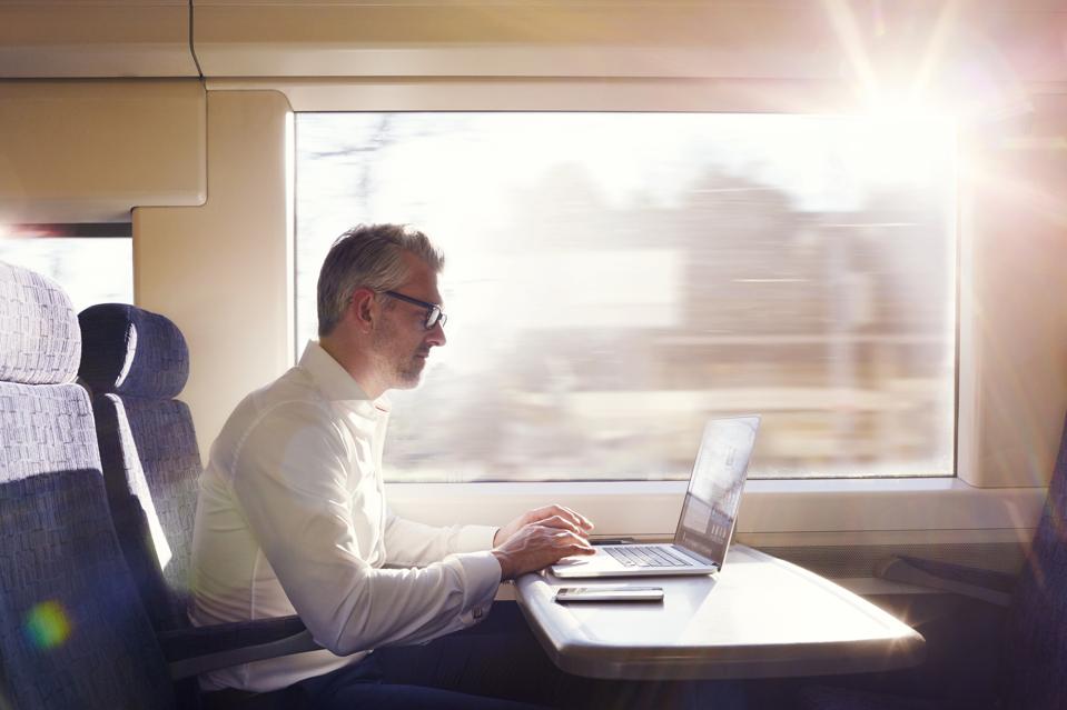 Businessman working on a commuter train.