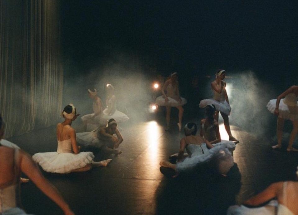 Ballet dancers from Ukraine stretch and ready themselves onstage before a performance. 