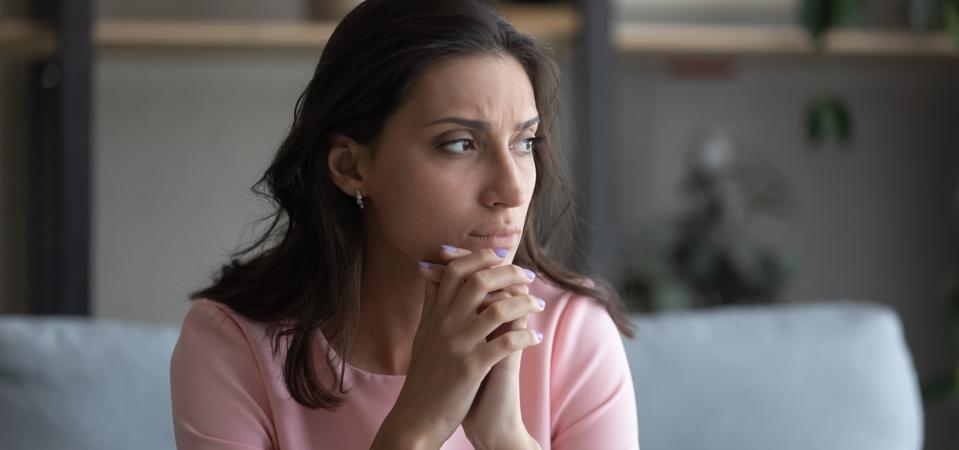 Anxious Arabic woman feel unhappy thinking at home