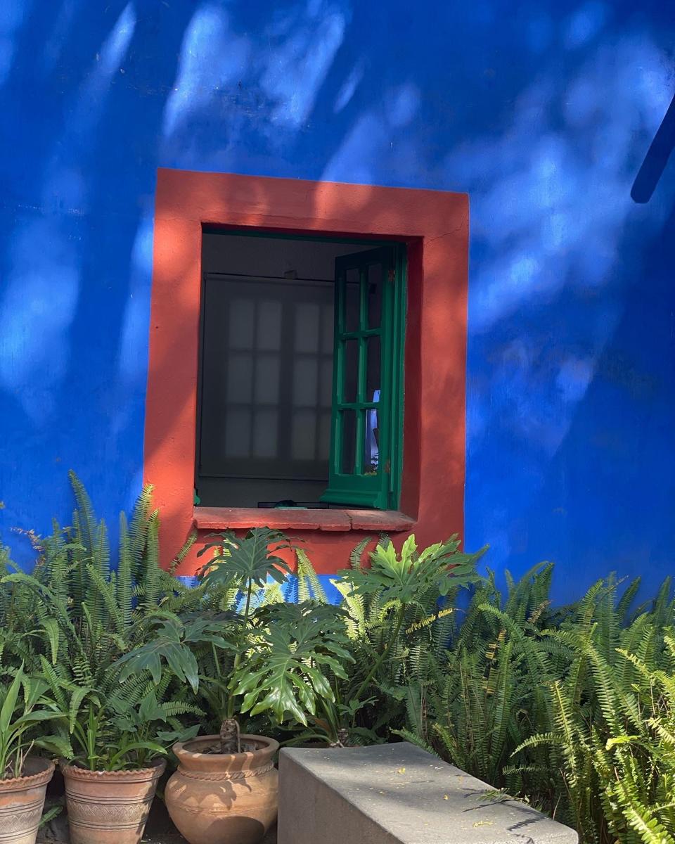 A photograph taken by Elizabeth Karmel of the exterior of Frida Kahlo's Casa Azul a.k.a., Blue House, in the Coyoacan neighborhood of Mexico City.