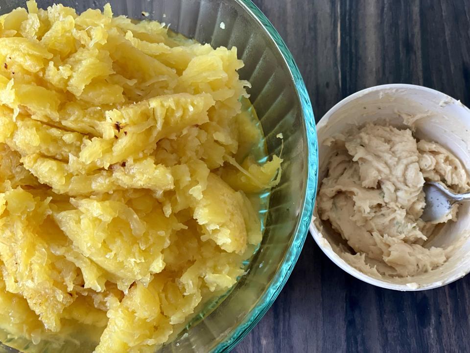 Warm spaghetti squash is mixed with Miso Butter for a vegetable side dish that is simple but utterly delicious.In this photograph by Elizabeth Karmel is a bowl of the warm squash and a separate bowl of Miso butter before mixing together.