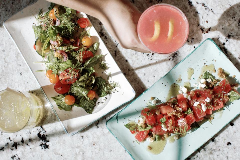 Platters with fresh fruit and vegetable salads.
