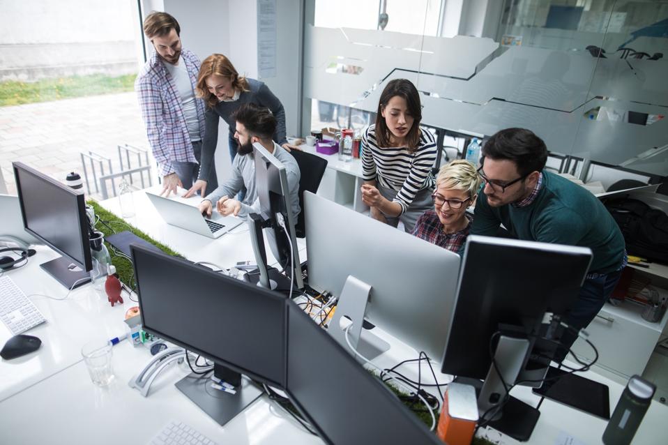 Web designers working in office on project together