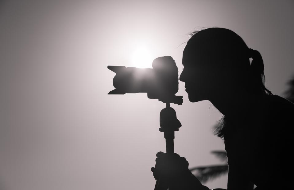 Female photographer taking pictures outdoor