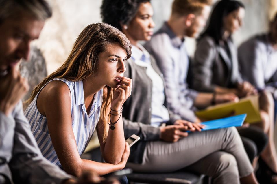 Young businesswoman feeling worried while waiting for job interview.