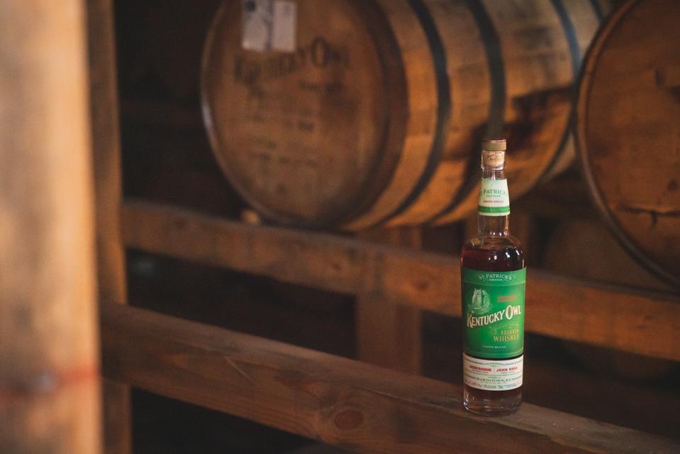 Bottle of whisky with barrels in background