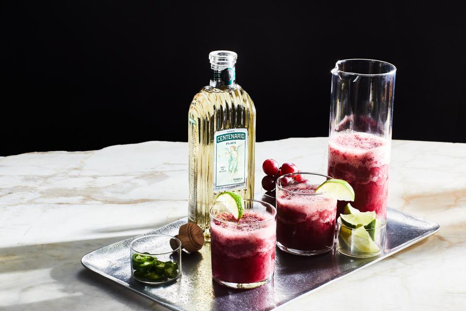 Watermelon Grape Margarita and bottle of tequila centenario