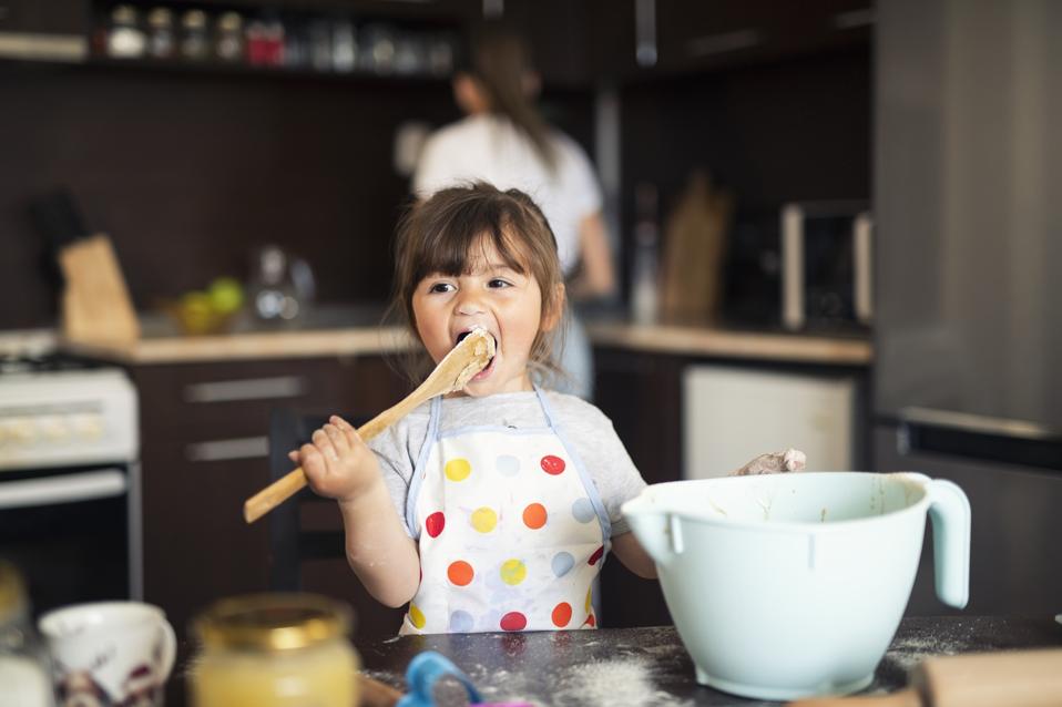 Cute little girl baking at home with mom