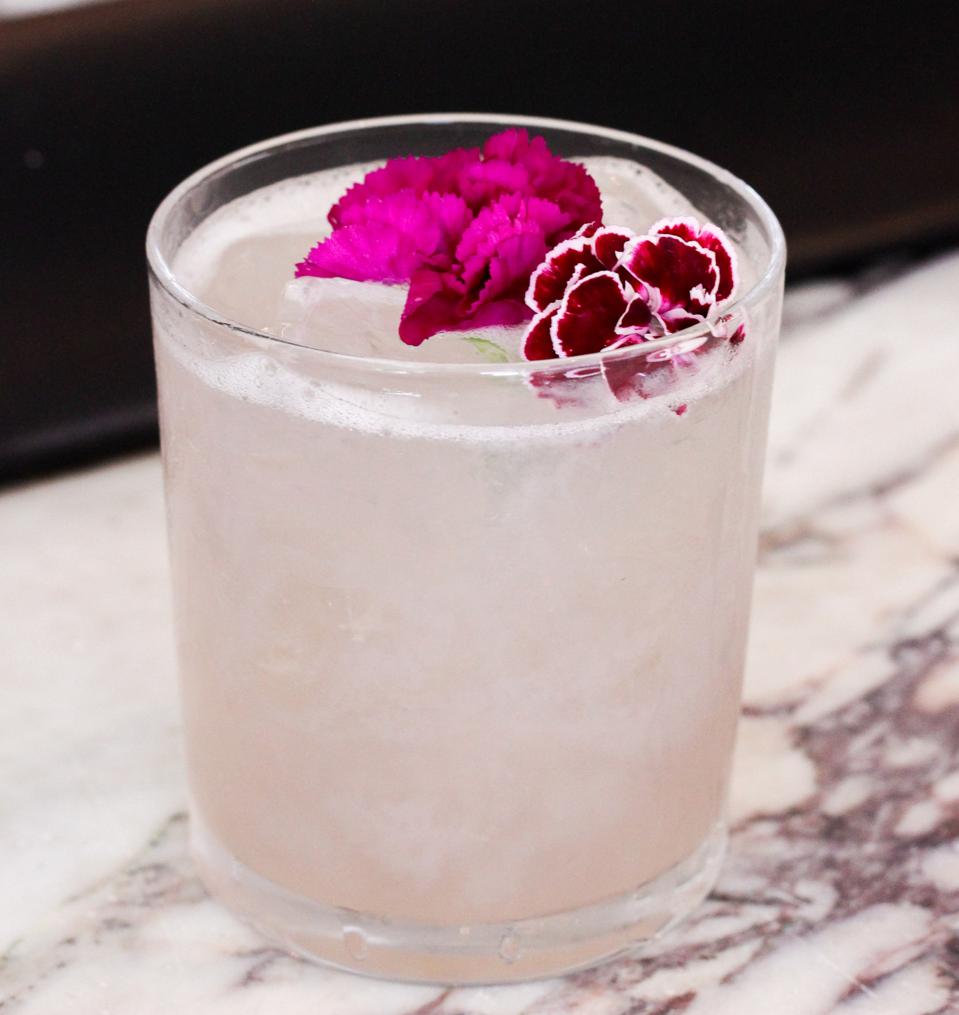 Secret Garden cocktail garnished with flowers