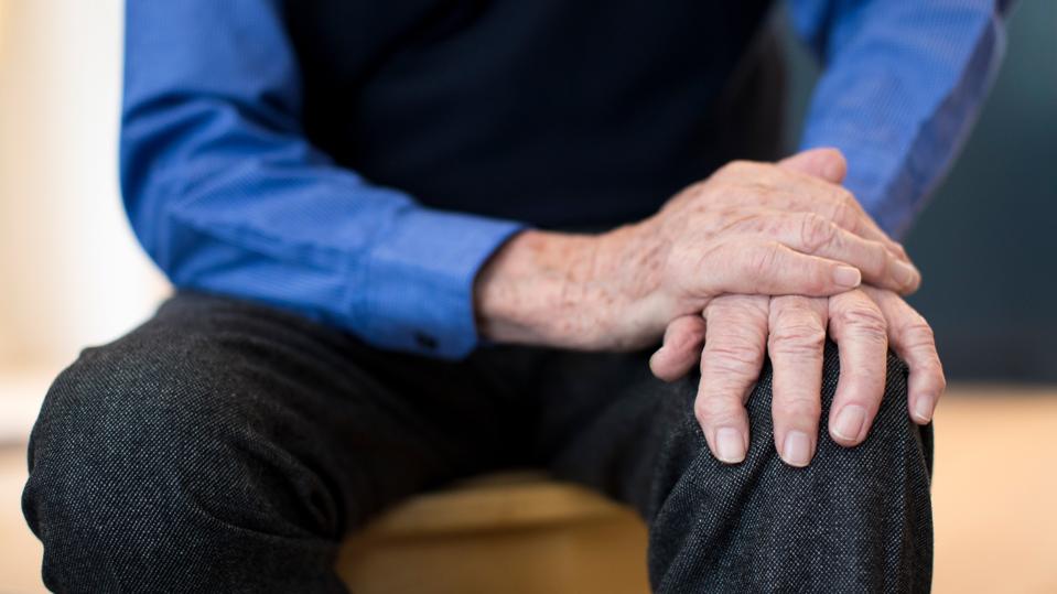 Close Up Of Senior Man Suffering With Parkinsons Diesease