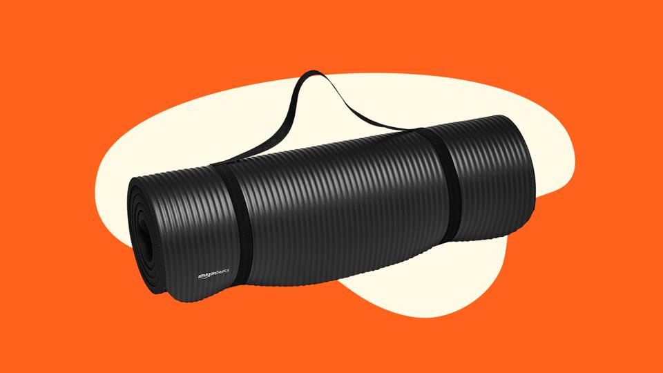 The Amazon Basics Yoga Mat rolled up on a orange illustrative background.