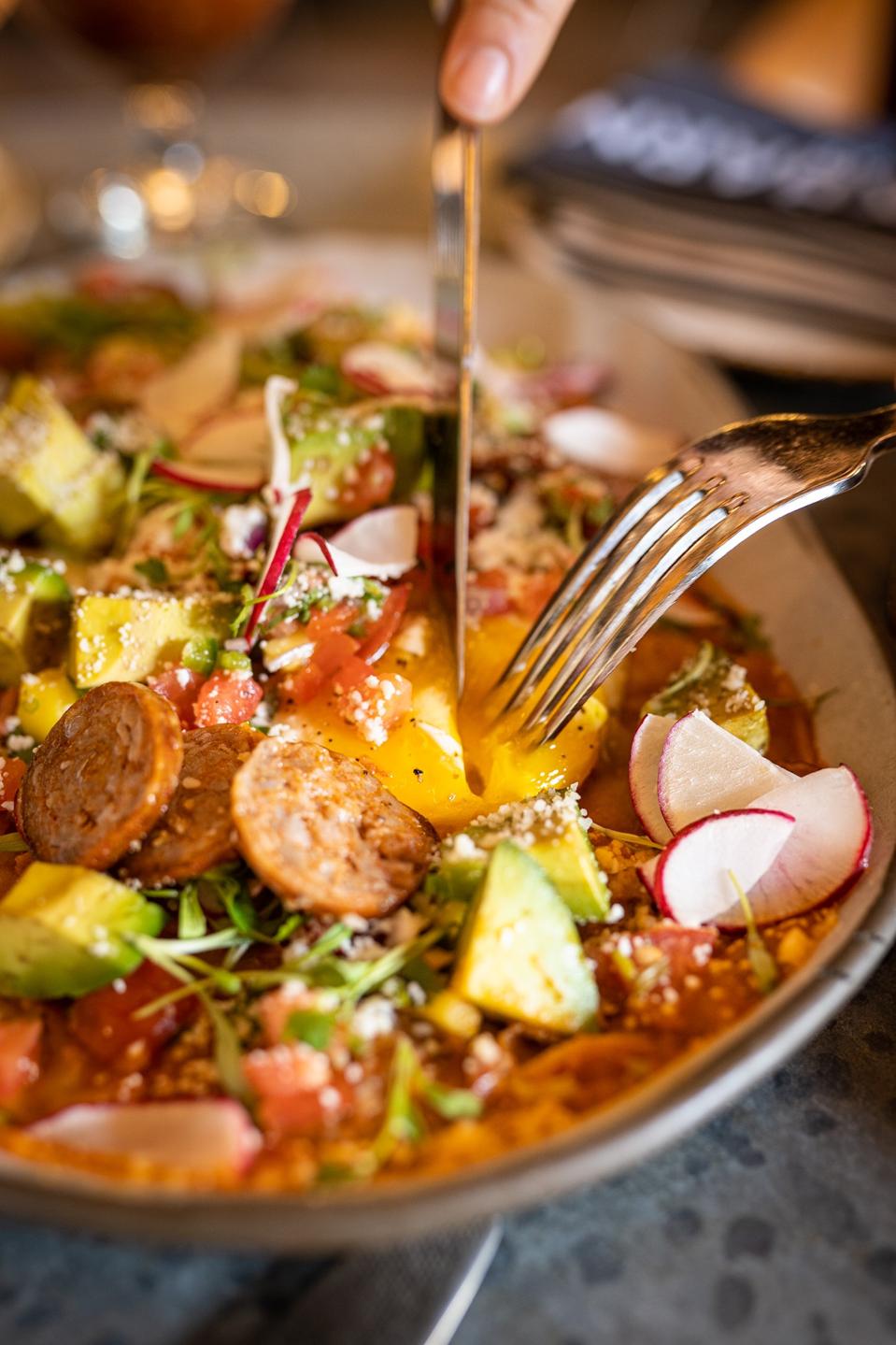 Huevos Chilaquiles, tomatillo salsa, cotija cheese, avocado, chorizo, radish, mango pico de gallo 2