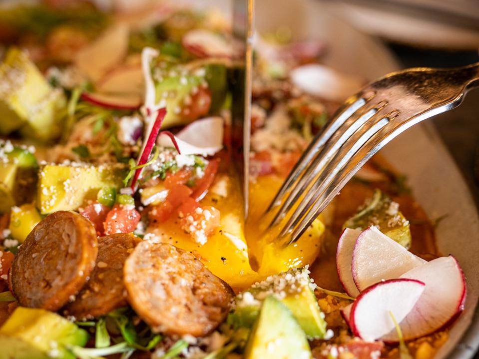 Huevos Chilaquiles, tomatillo salsa, cotija cheese, avocado, chorizo, radish, mango pico de gallo 2