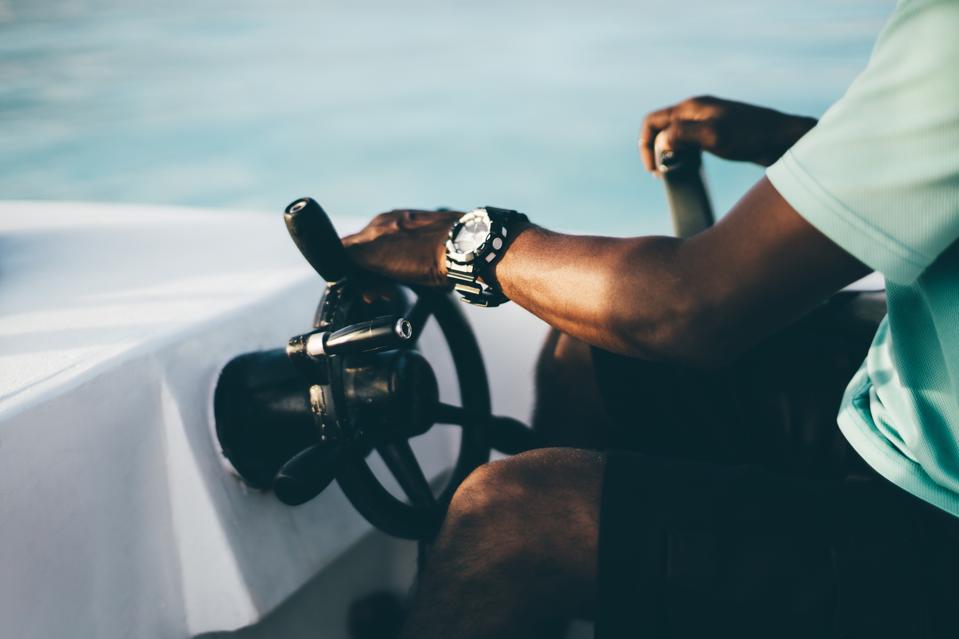 Man driving a boat; captain concept