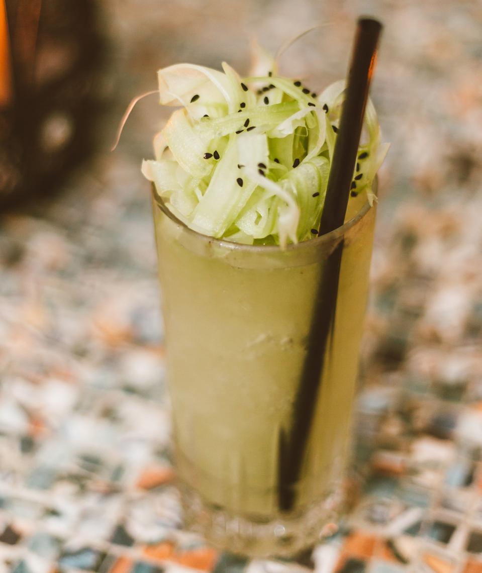 Light green cocktail in a tall glass