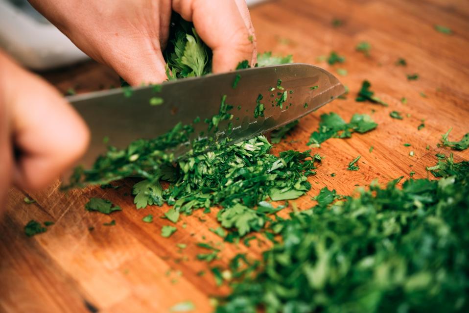 Cutting parsley in a kitchen.