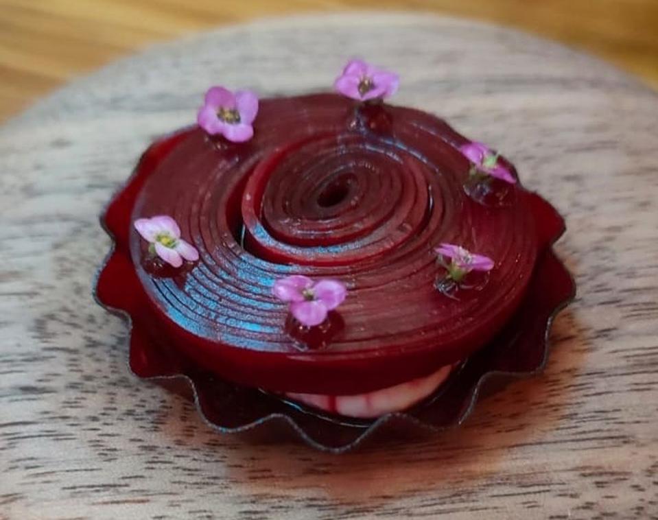 a beetroot rose on a wooden plate