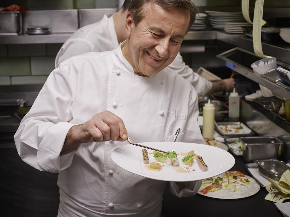 Chef Daniel Boulud plating in the kitchen