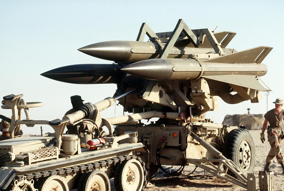 U.S. Army personnel deploy an MIM-23B Hawk surface-to-air missile system in the desert during Operation Desert Shield.