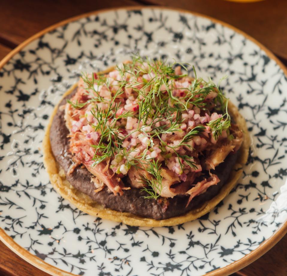 sope de lechon on a blue and white plate