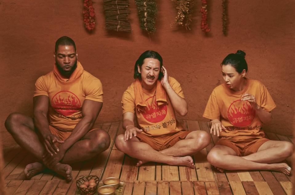 Two men and a woman sit in a Korean sauna rapping.