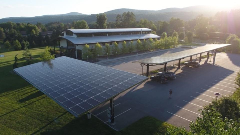 Solar panels provide electricity and shade the parking lot at The Alchemist in Stowe, VT.
