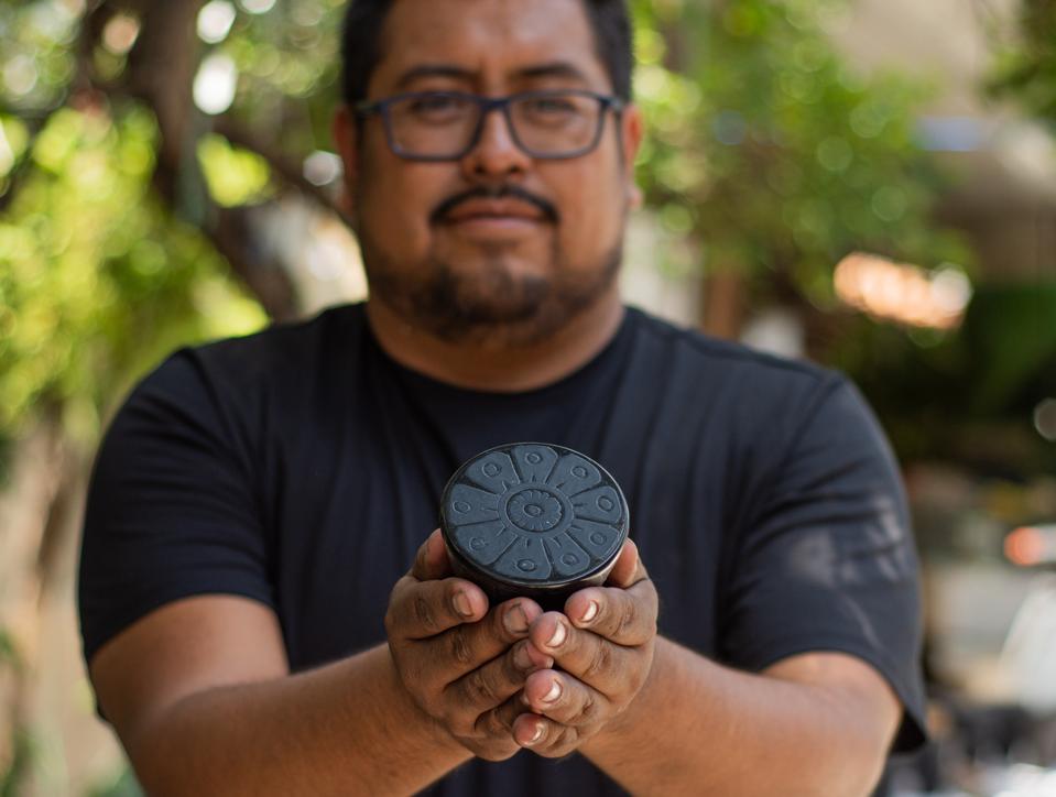 Adolfo Escudero García holds a bottle stopper