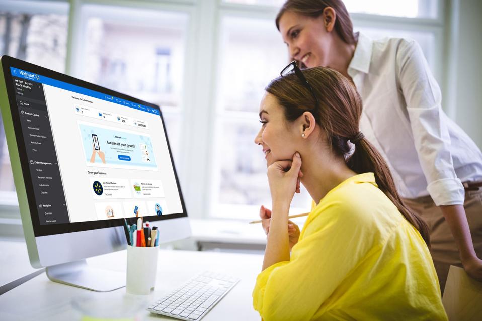 two businesswoman looking at a computer