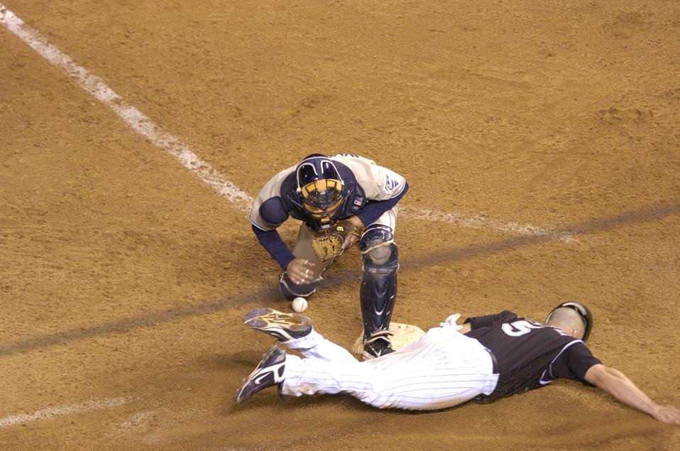 (ga) ROCKIES_PADRES TIE BREAKER - Matt Holiday slides past the plate to score the winning run as Padres catcher Michael Barrett drops the ball in the Rockies' 9 - 8 13th inning victory during the tie breaker game against the San Diego Padres for the Natio