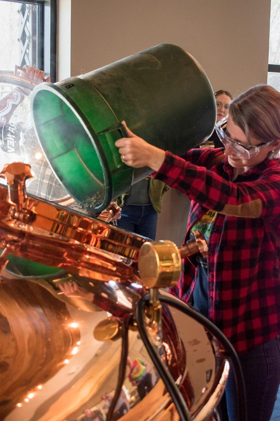 A brewer adds hops to a beer at Sierra Nevada Brewing.