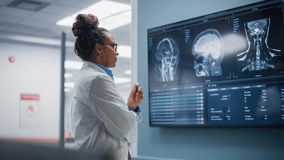 Radiologist examines patient imaging. 