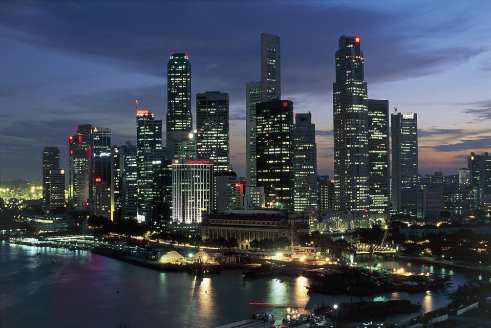 Skyscrapers lit up at night in a city, Singapore City, Singapore