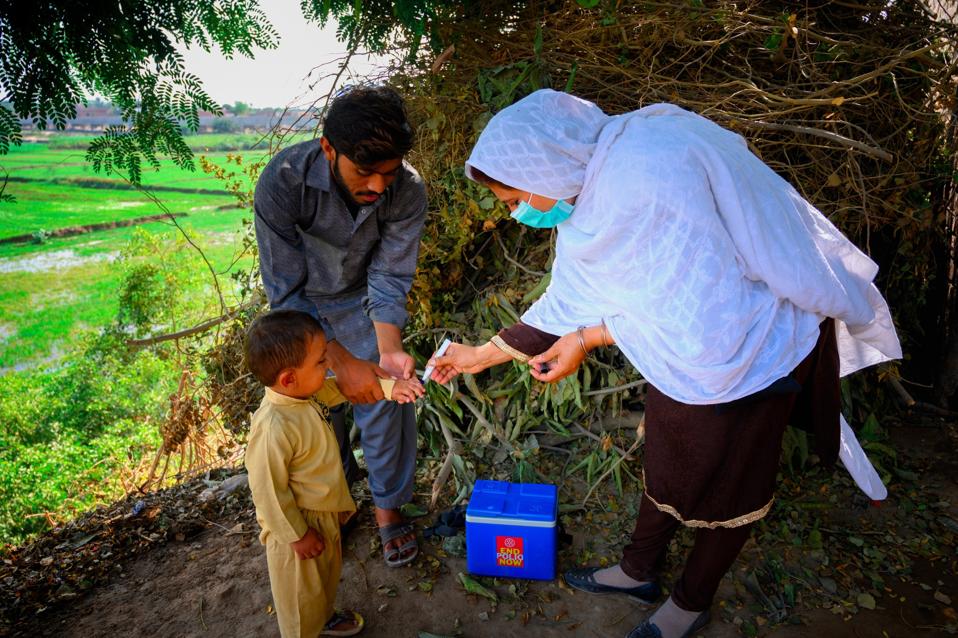 Programme (Syed Mehdi Bokhari on 26-10-2020) — Polio workers Tahmina Bibi, age 27, is marking a finger after vaccinating a 2.5-year-old boy in the presence of his brother on sub-national immunization day.