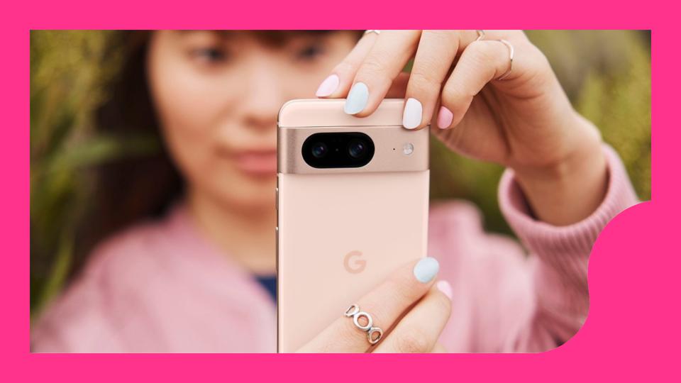 A woman holding up a rose-colored Pixel 8 phone.