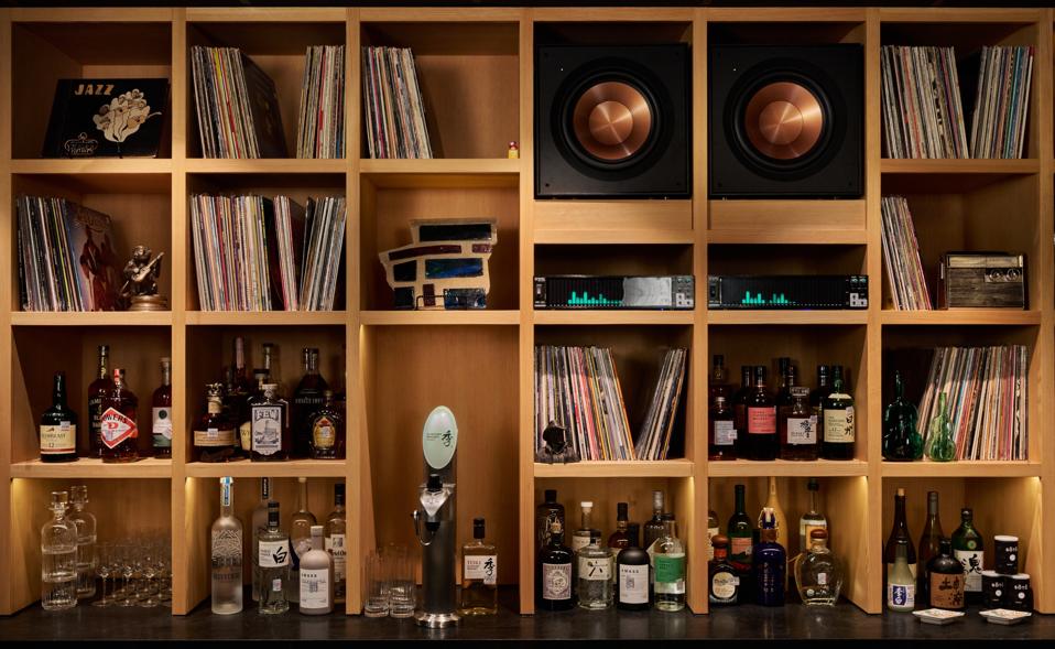 bar shelves with bottles and vinyl records.