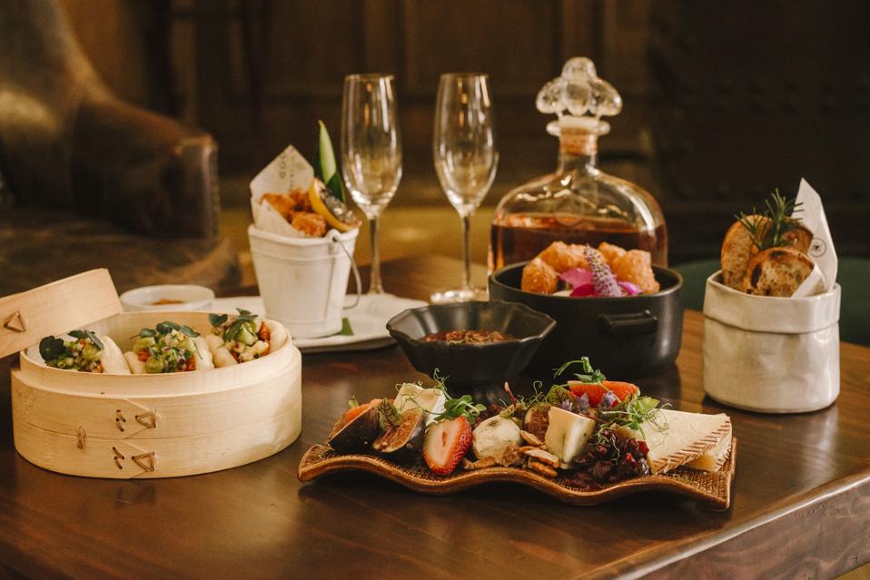 a selection of appetizers and a bottle of tequila