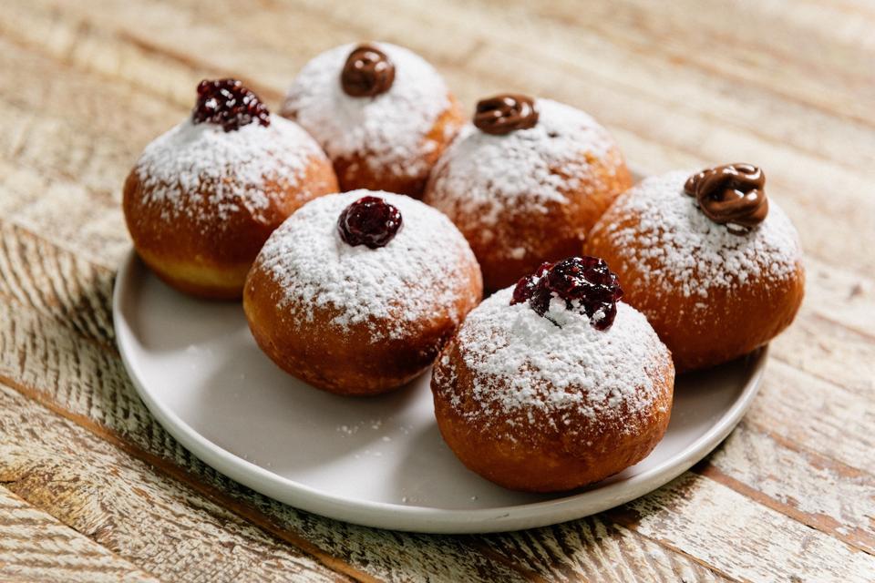 Sufganiyot - Chanukah doughnuts.  One filled with nutella and the other filled with raspberry jam