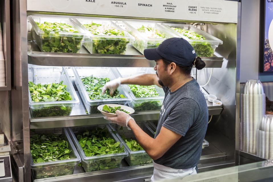 Washington DC, Chinatown, Chop't, restaurant server getting greens for salad preparation