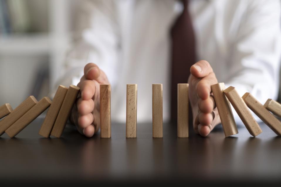 Hands preventing domino effect