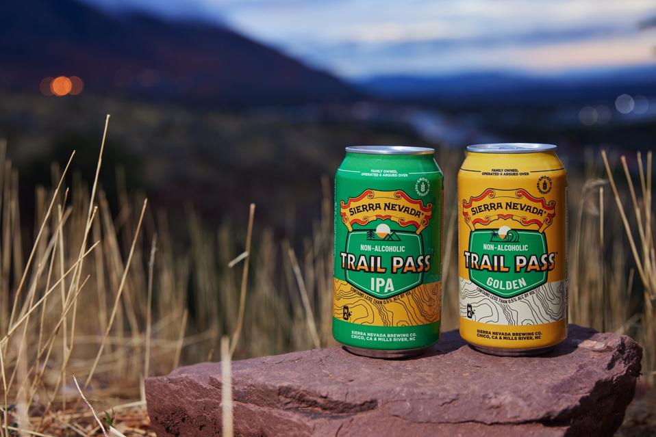 Two cans of Sierra Nevada Trail Pass non-alcoholic beers, IPA and Golden.