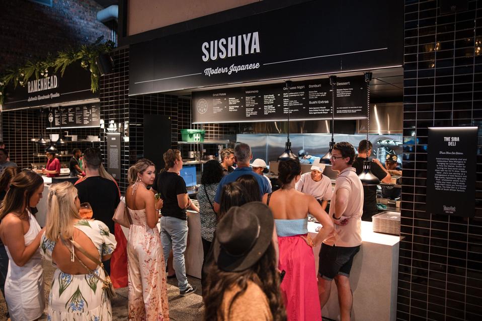 Diners waiting in line to order at Sushiya at Time Out Market Cape Town.