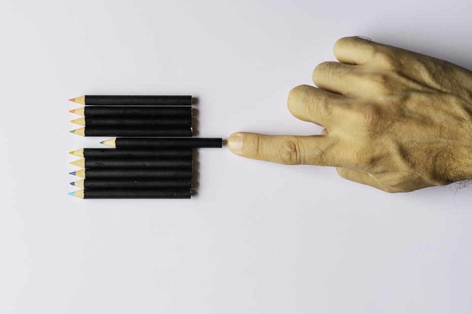 Obsessive compulsive disorder, male hand obsessively ordering some colored pencils